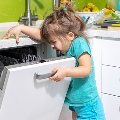 Child smelling a dishwasher