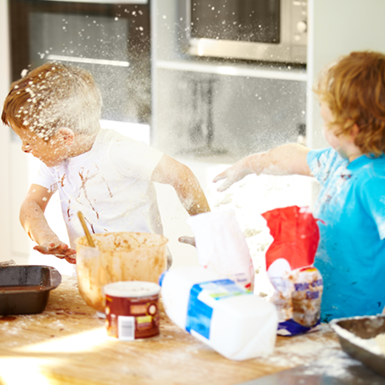 Children playing while baking in the kitchen