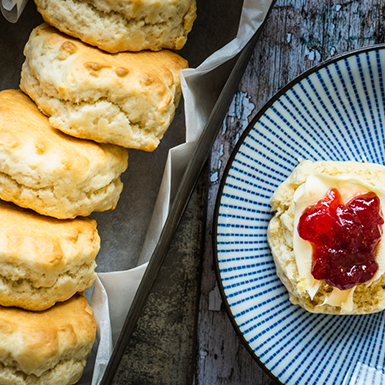 Scones on a plate with cream and jam