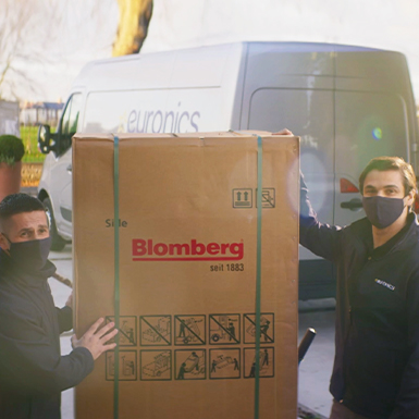 Euronics agents delivering a new fridge