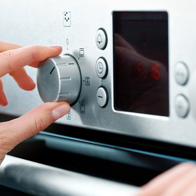 Person adjusting the temperature on the oven