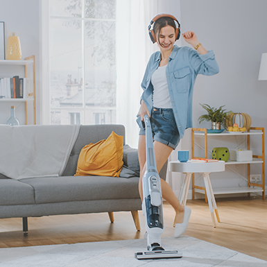 Woman dancing while vacuuming