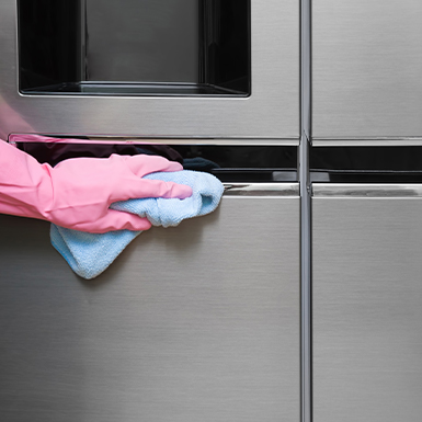 Person cleaning fridge doors